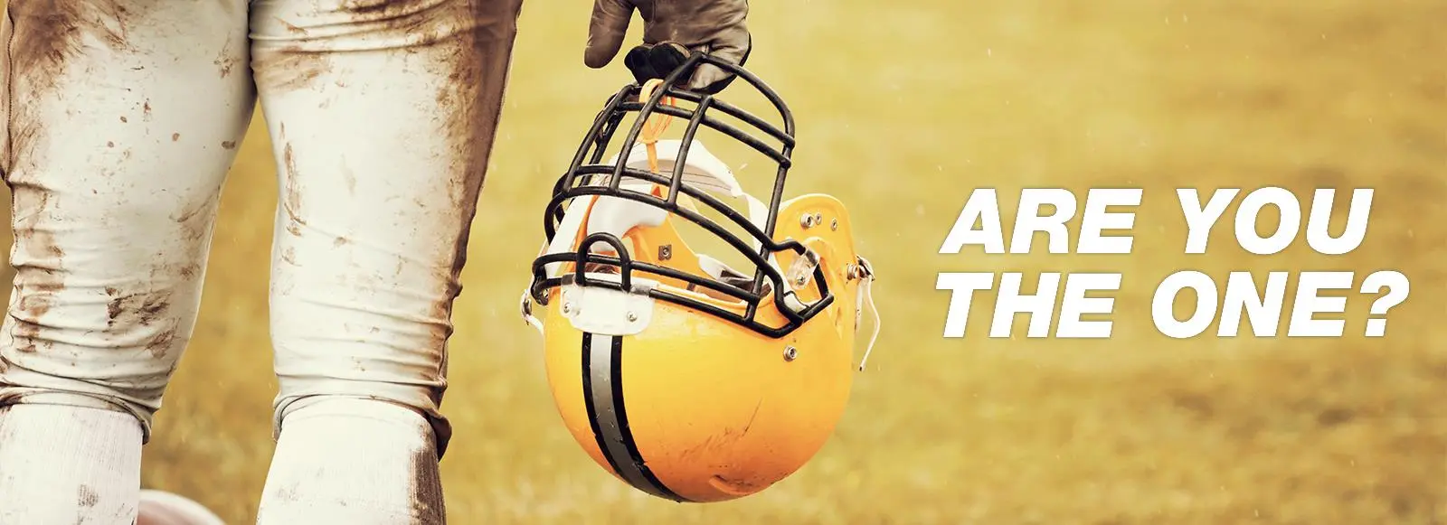 Football player holding helmet